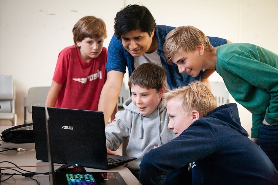 Rafid working with a group of campers